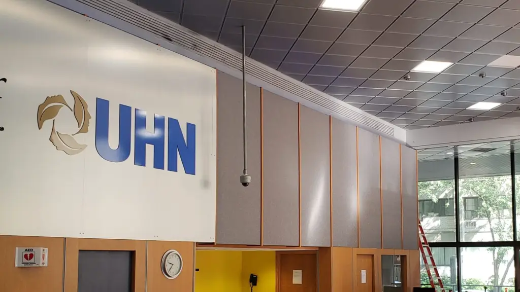 Hospital reception desk staffed and operating while renovation work continues nearby