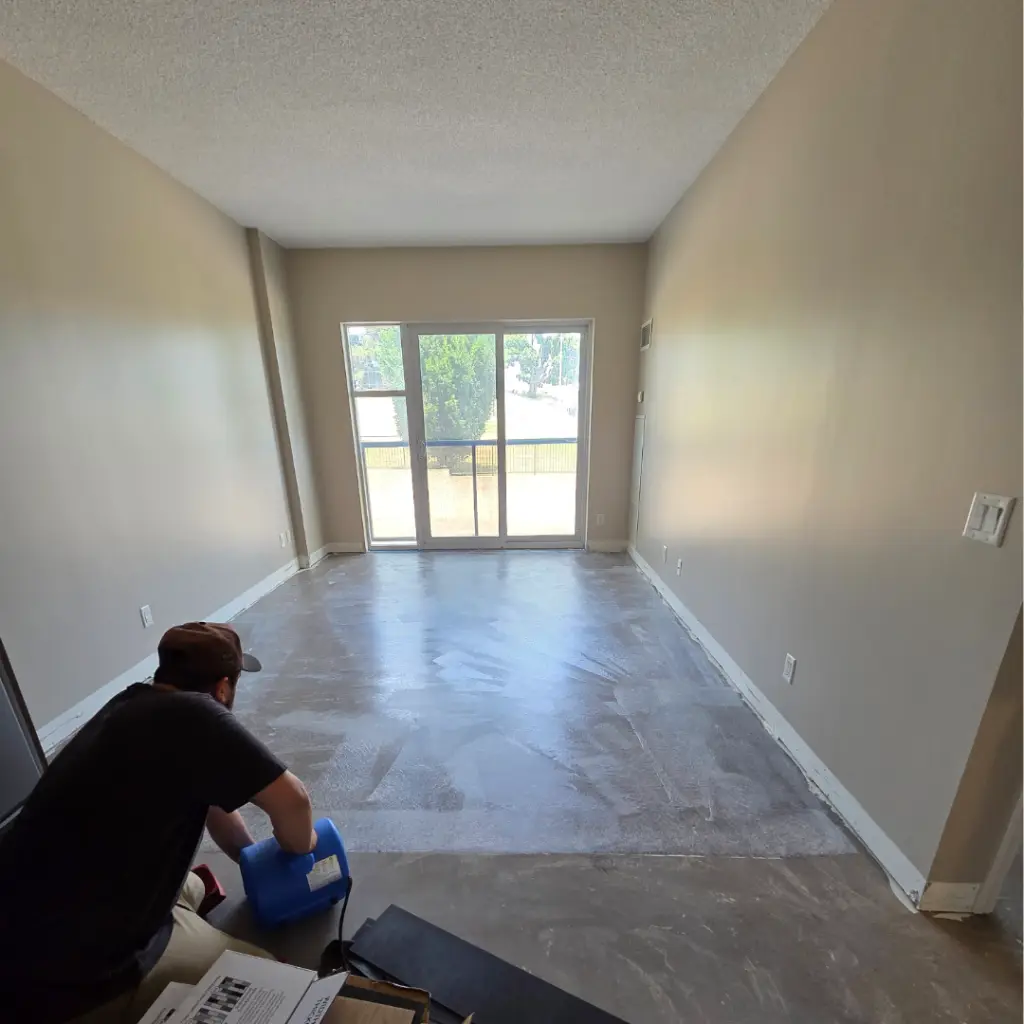 New luxury vinyl plank flooring being installed over a prepared subfloor