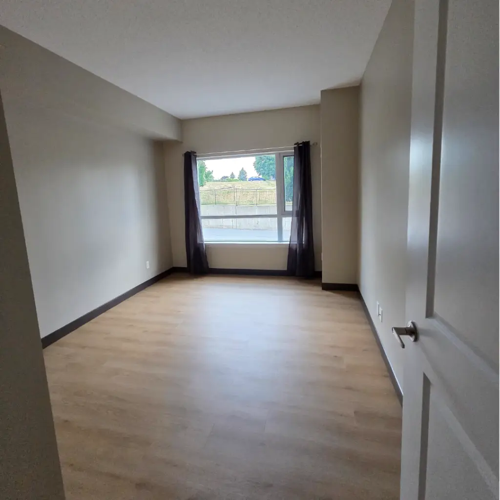 Completed senior living suite with new flooring and fresh paint, ready for turnover