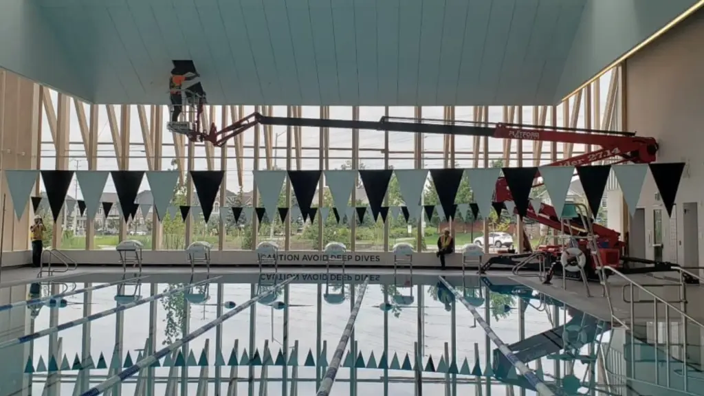Boom lift ceiling work above the pool at a Life Time aquatic centre