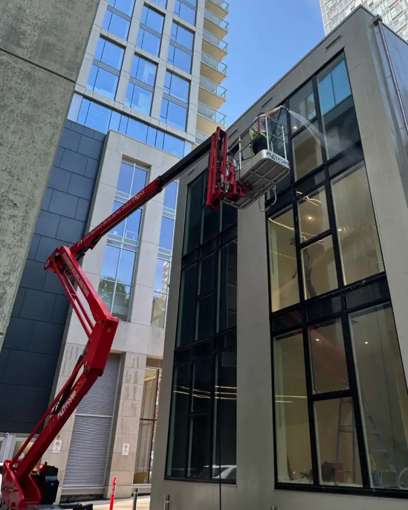 UBS boom lift positioned for exterior works on an occupied office building in downtown Toronto