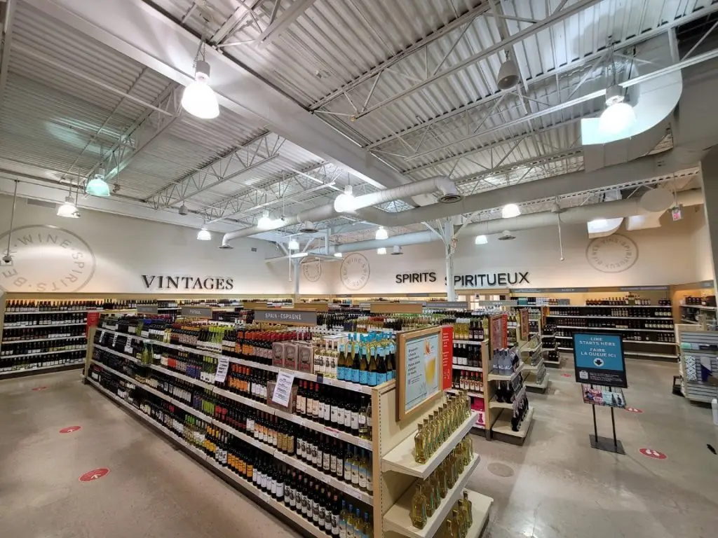 Completed LCBO store interior with wine and spirits shelving beneath exposed structure