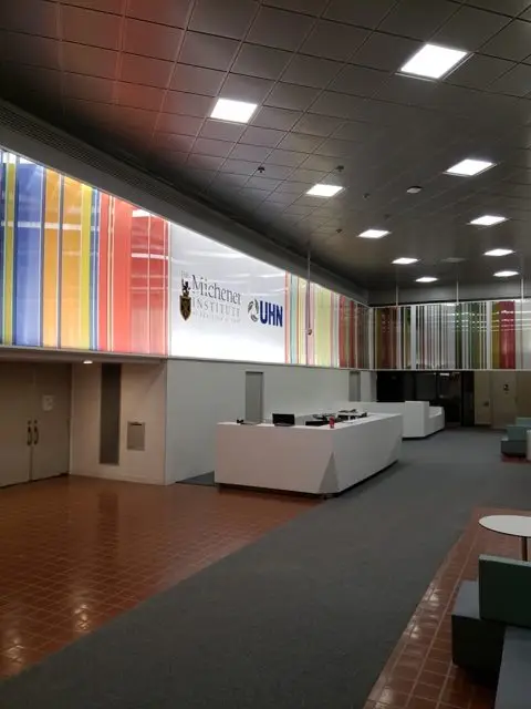 Completed lobby at the Michener Institute at UHN with new reception desk and backlit feature wall