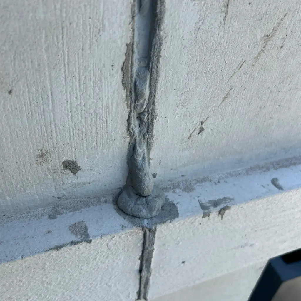 Sealant detail at a panel joint where water ingress can begin