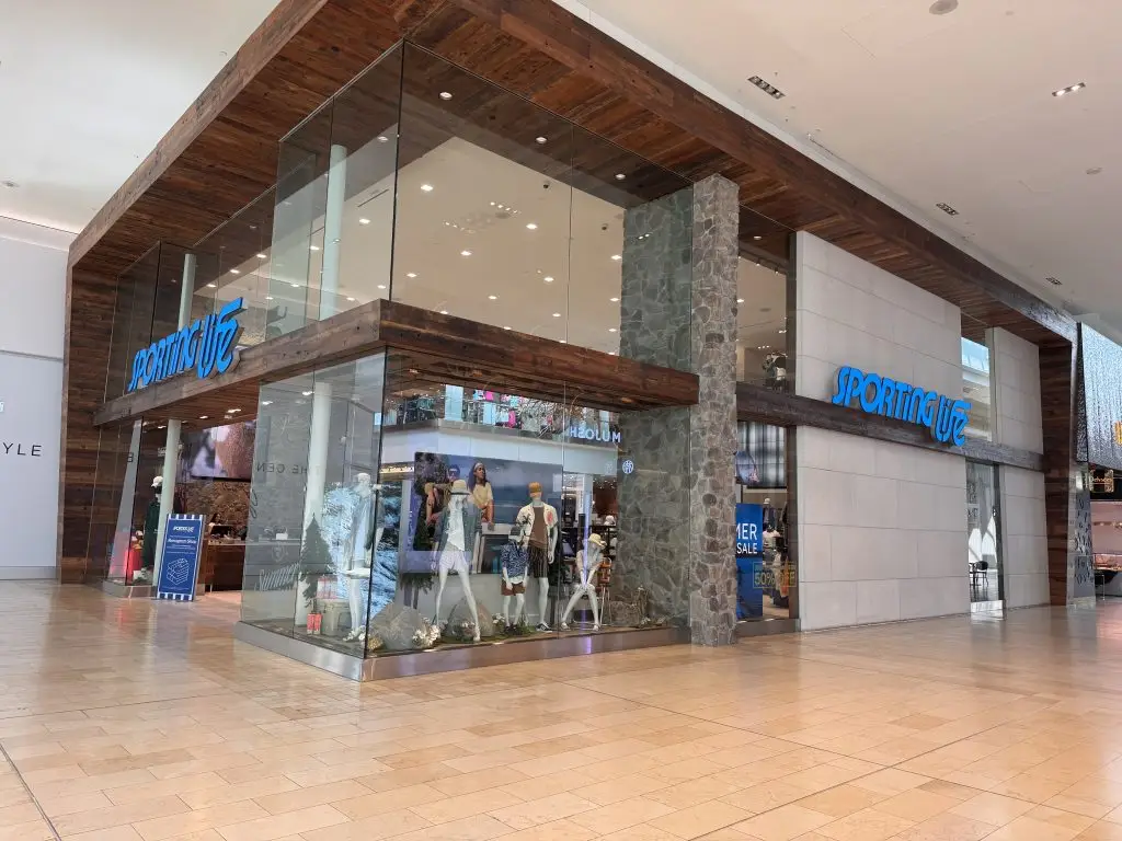 Completed Sporting Life storefront with timber, stone and full-height glazing in a shopping centre
